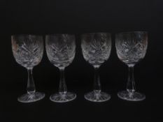 A set of four Thomas Webb Crystal wine glasses all with cut decoration in original box