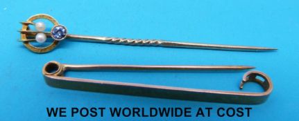 A yellow metal sapphire and seed pearl pin marked 15ct and a 9ct gold tie pin