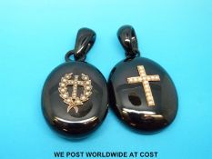 Two jet lockets set with seed pearls in a cross