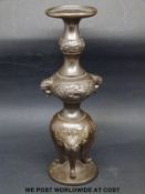 A bronze bud vase / incense holder, raised on masked feet, height 18.