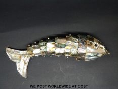 A mother of pearl and abalone fish with reticulated body and storage compartment to mouth