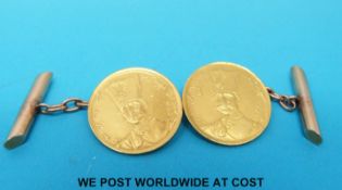 A pair of gold cufflinks each set with a coin (7.