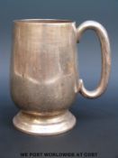 A hallmarked silver pint tankard, 13cm tall,