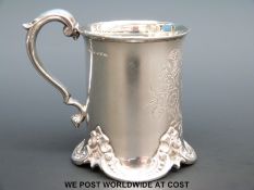 A Victorian hallmarked silver christening mug with ornate decoration to base,