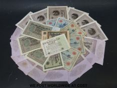 A quantity of WWII German banknotes including 18 x 100,000 mark notes,