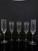 A collection of 17 Villeroy and Boch champagne flutes together with eight other etched champagne