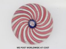 Clichy swirl glass paperweight with alternating pink and white spiralling decoration around a
