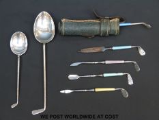 A novelty white metal and guilloché enamel handled manicure set formed as a bag of golf clubs each