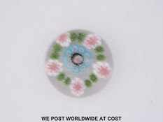 Clichy patterned millefiori glass paperweight with central purple,