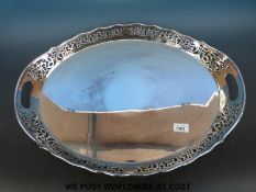 A large oval silver plated tray (diameter 58cm) together with a cased set of plated teaspoons