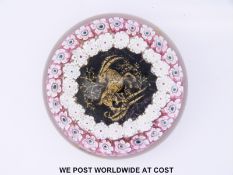 Five Murano millefiori glass paperweights, the largest with three blocks of red,