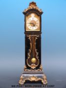 A miniature long case clock in ebonised case,