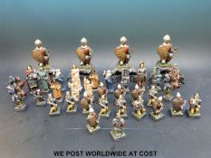 A stylised chess set of medieval style and four corner knights to support the board