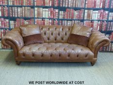 A three seat brown leather Chesterfield sofa (width 240cm)
