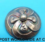 A Georg Jensen silver brooch in the form of a stylized flower, 6.6g, 3cm in diameter.
