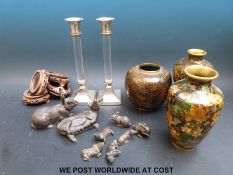 A pair of silver plated candle sticks with acrylic columns,