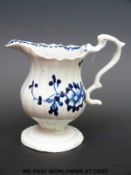 A 18thC blue and white pedestal cream jug, probably Liverpool,