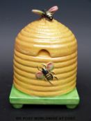 A Carltonware honey pot in the form of a hive with bee finial lid