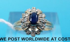 A 14ct gold ring set with a sapphire surrounded by diamonds (size K)