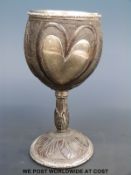 A Victorian carved coconut goblet with hallmarked silver mounts, metal heart emblem, carved figure,