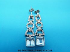 A pair of Art Deco 18ct white gold earrings each set with an emerald cut aquamarine of