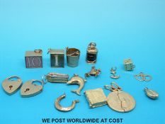 Fifteen 9ct/yellow metal charms to include dice, heart padlocks, dolphins, etc (27.