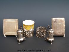 Two hallmarked silver cigarette cases together with two hallmarked silver peppers and two