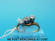 An 18ct gold ring set with three diamonds in a twist setting (size I)