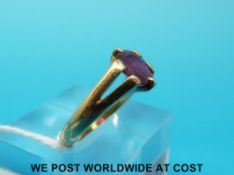 A yellow metal ring marked 18ct set with an oval ruby (size O)
