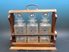 A Walker & Hall silver plated and oak tantalus