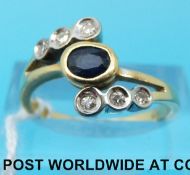An 18ct gold ring set with a sapphire and diamonds (size O)