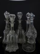 Three graduated glass decanters and two others