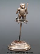 An Edward VII hallmarked silver hat pin stand with bear to top,