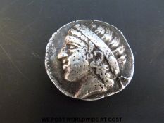 A silver Greek coin approximately 28-30mm Pegasus reverse