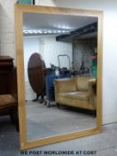 A large oak or similar framed mirror (123cm x 177cm)
