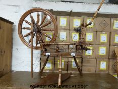 An oak spinning wheel with turned supports