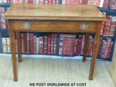 An oak fold-over occasional table with single drawer (width 89cm, depth 44cm,