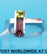 A white metal ring marked 14k set with pink and green tourmaline (size O)