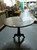A 19thC oak circular tilt top table (diameter 72cm)