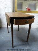 A small oval topped drop leaf side table together with a small oak tilt-top table and a small oval