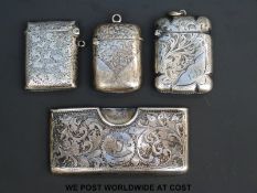 Three hallmarked silver vesta cases and a hallmarked silver card holder with embossed floral