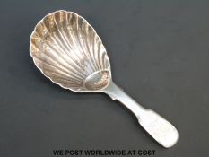 A Georgian hallmarked silver fiddle pattern caddy spoon with shell design to bowl,