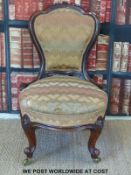 A 19thC carved mahogany nursing chair