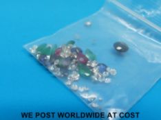 A collection of loose gemstones to include sapphire, emeralds,