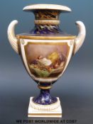 A Royal Worcester twin handled pedestal vase with hand decorated still life of fruit and jug on a