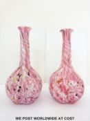 A pair of Nailsea style glass bottle vases of twisted form with aventurine flecks,