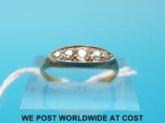 A yellow metal ring marked 18ct set with five diamonds (size L)