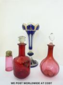 An overlaid glass vase with blue casing over clear ground and gilt decoration (32cm tall) together