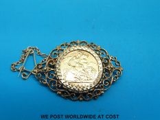 A yellow metal brooch set with a 1982 gold half sovereign (9.