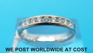 A white metal ring set with ten diamonds,